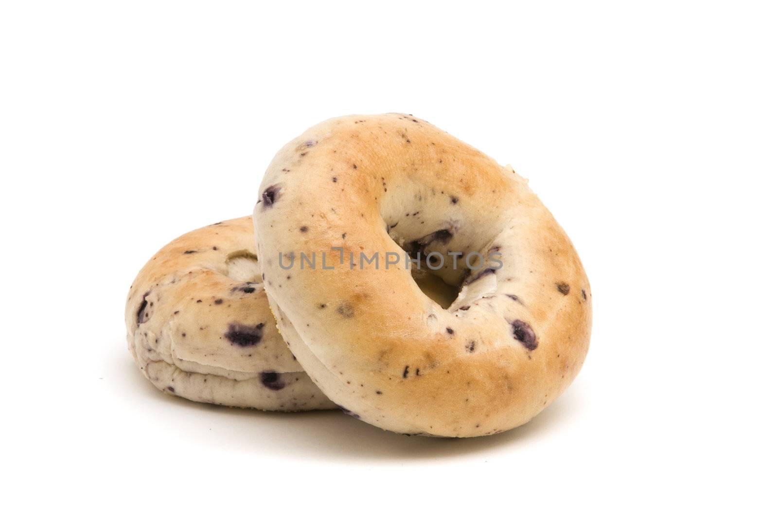Two blueberry bagels on a white background