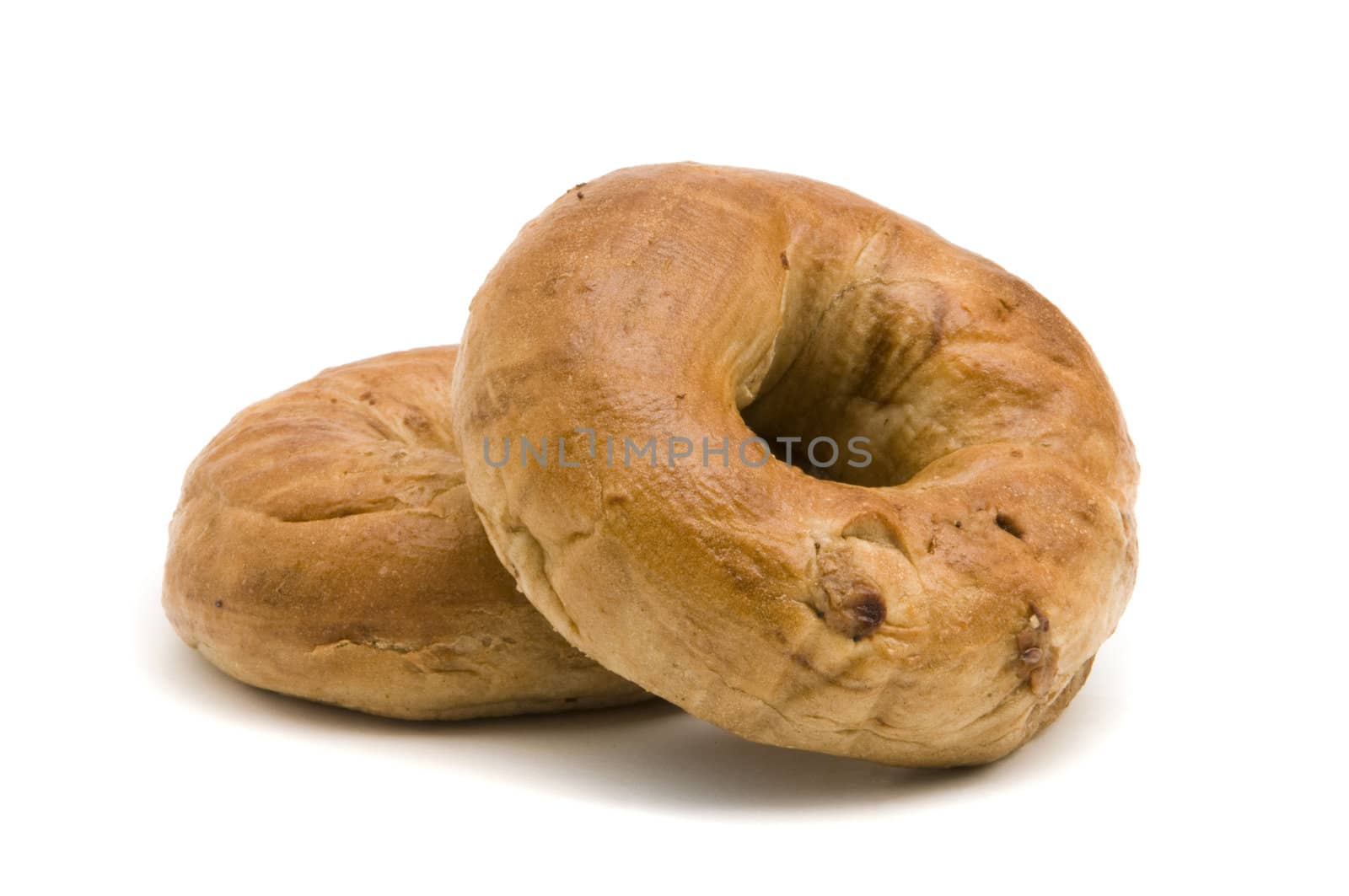 Two cinnamon bagels on a white background