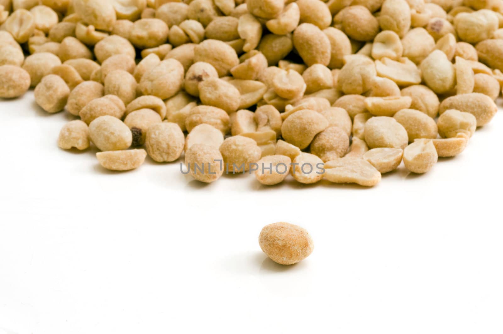Selective focus on the individual peanut in the foreground a group of peanuts