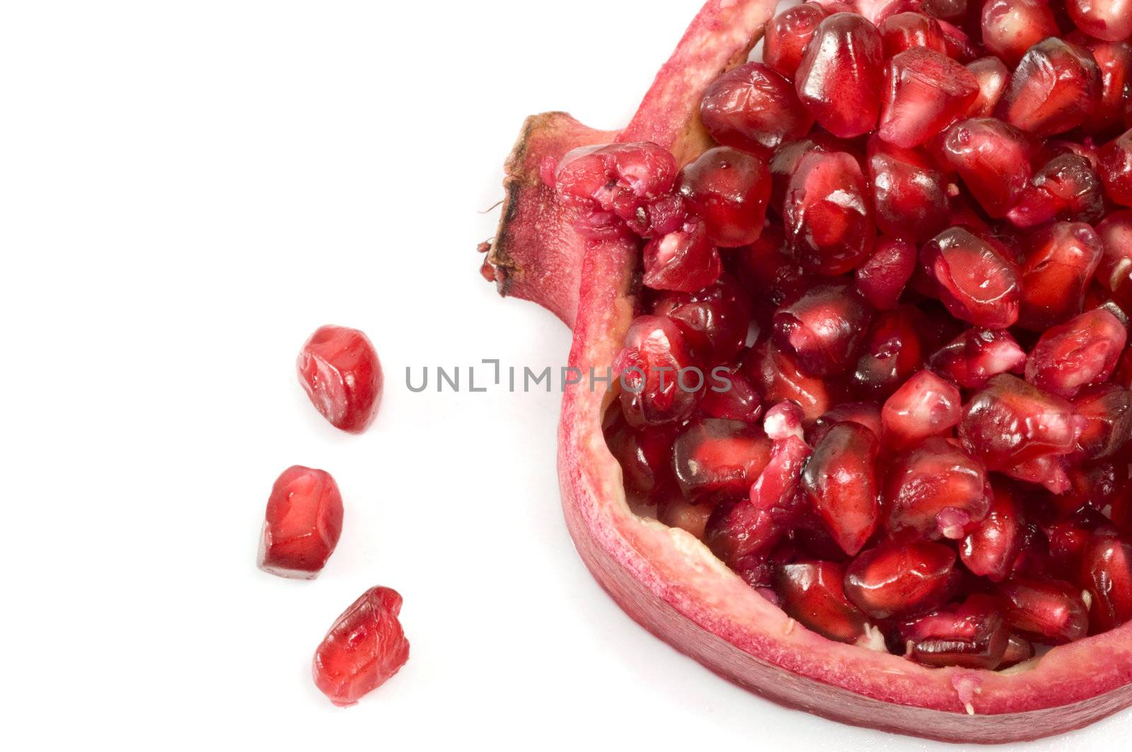 Pomegranate seeds and shell isolated on white background