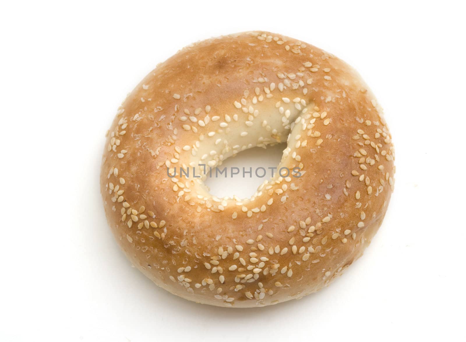 Single sesame seed bagel isolated on a white background.