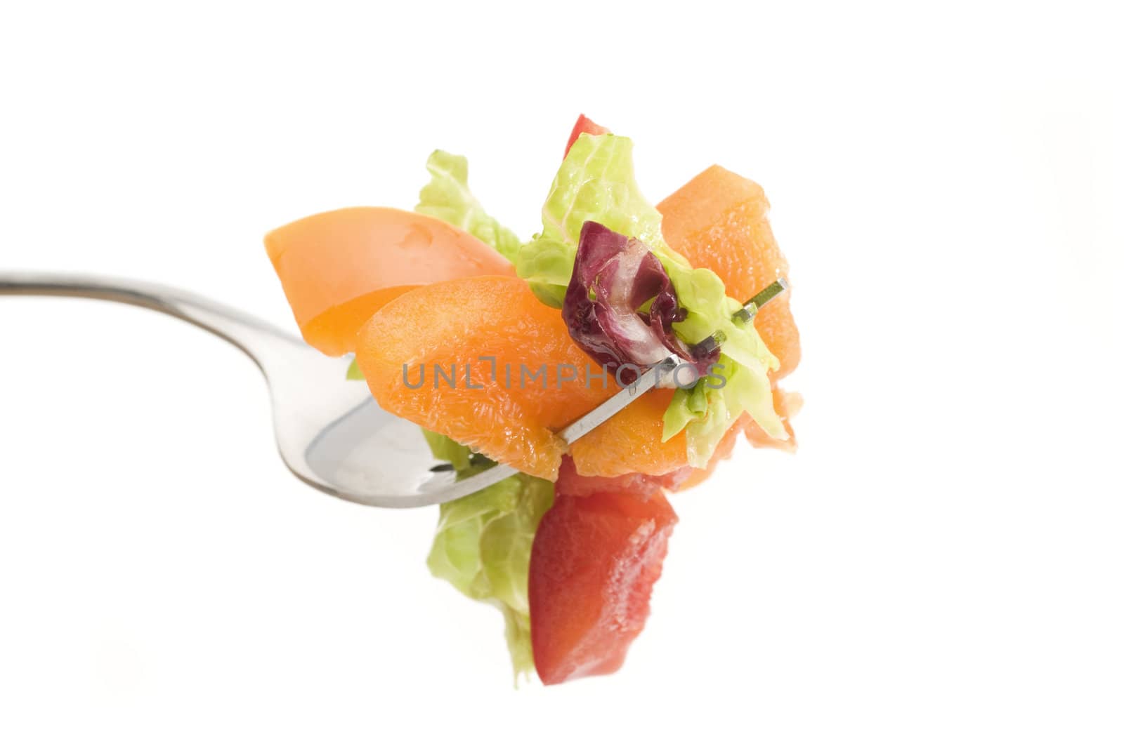 Selective focus on the foreground items on the fork of veggies with white background