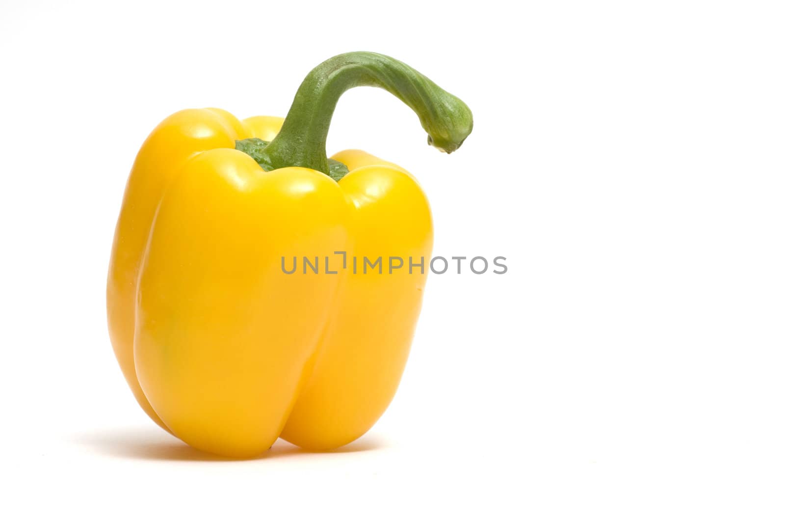 Single yellow bell pepper isolated on white.