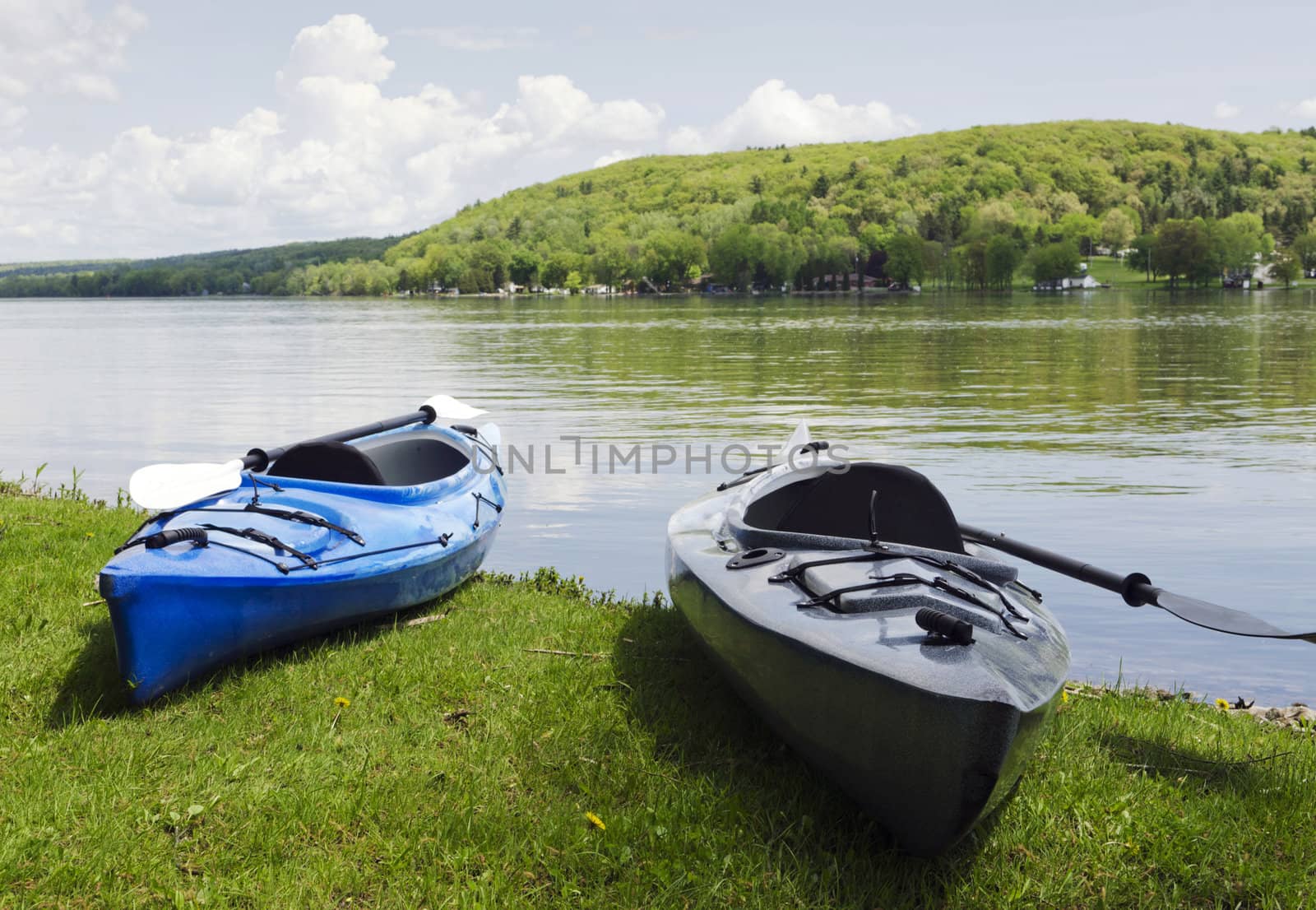 Two kayaks on the shoreline with the lake in the background