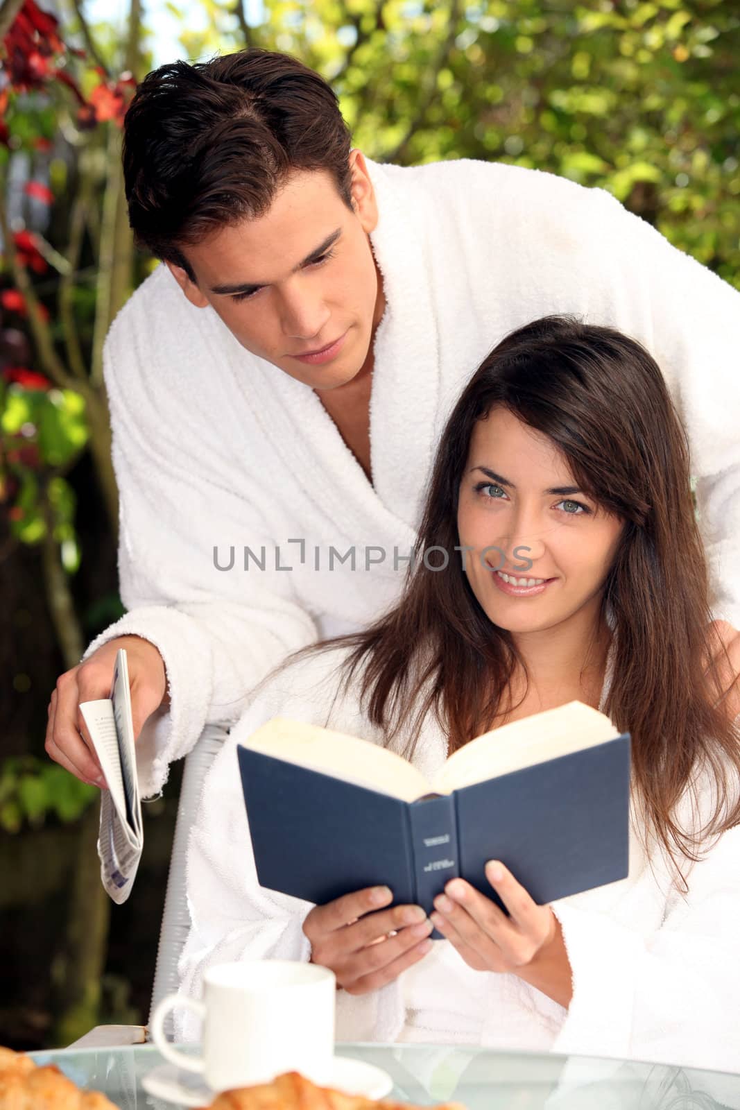 young couple having breakfast in garden by phovoir