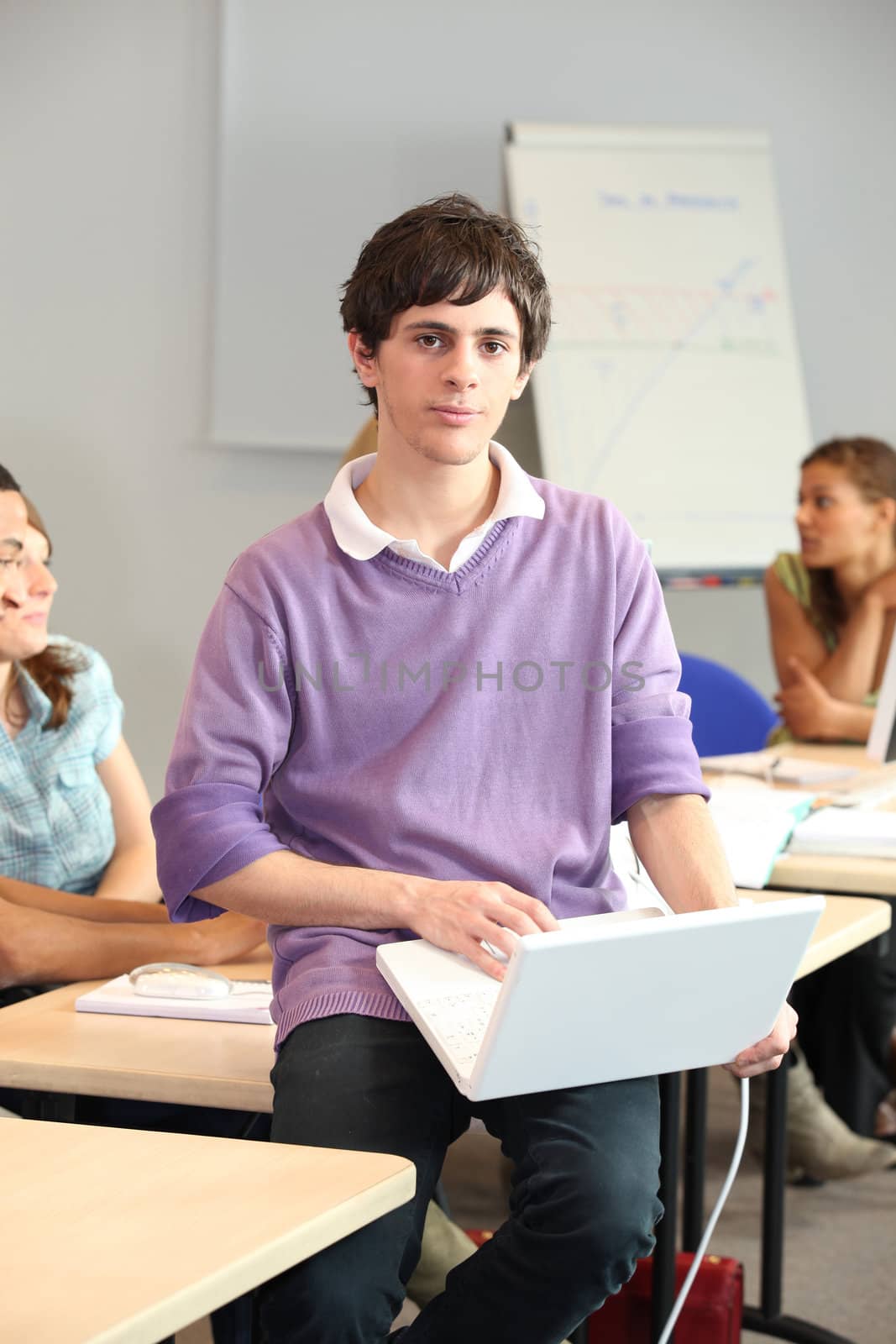 A young man at school with his laptop