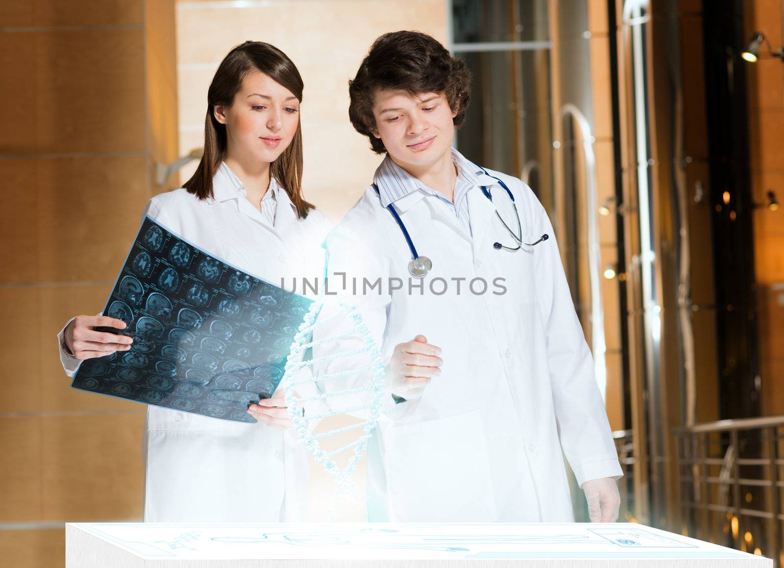 two doctors stand near glowing table discussing. projected objects on a desk