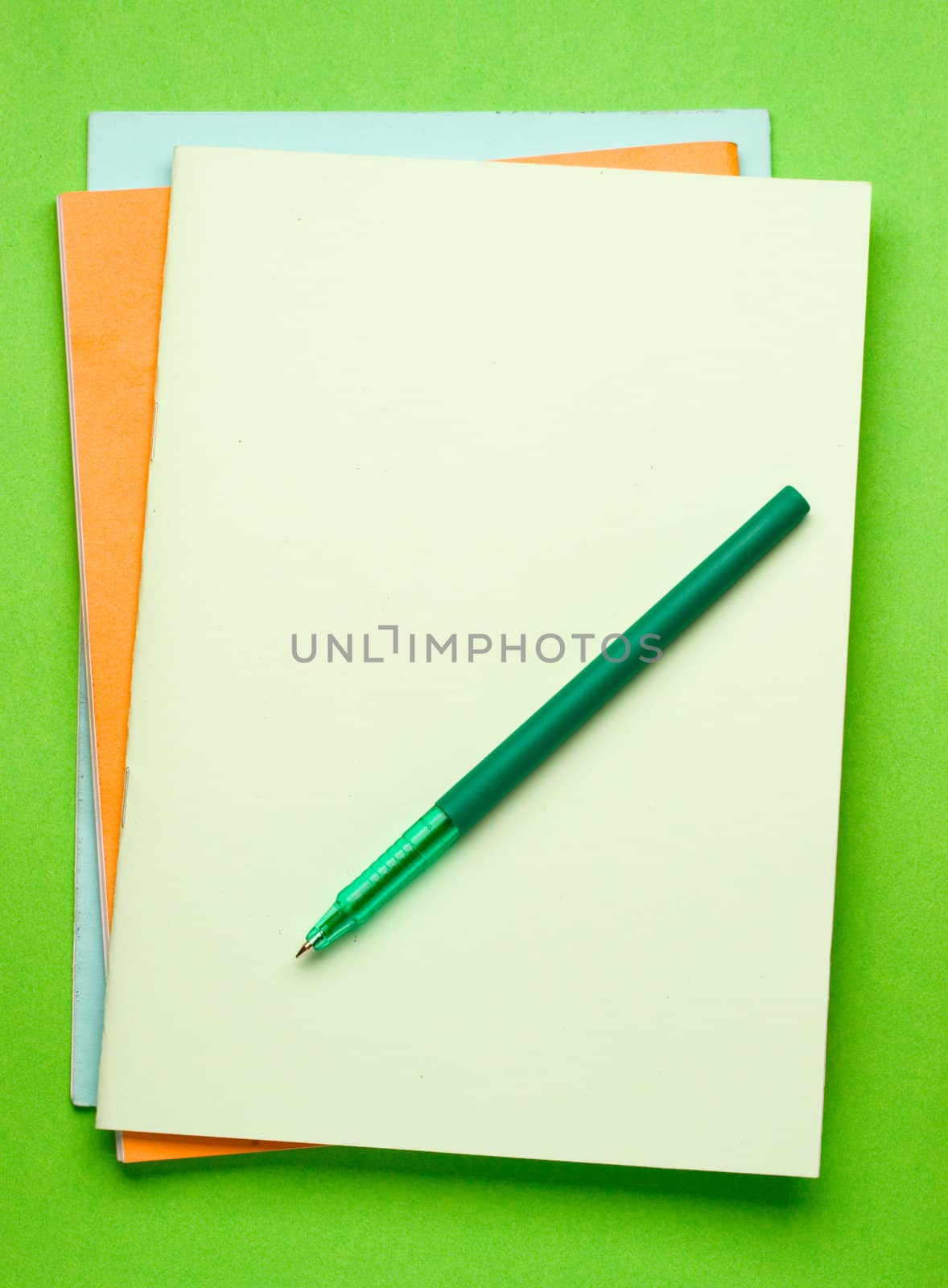 Notepads isolated on the green background by Garsya