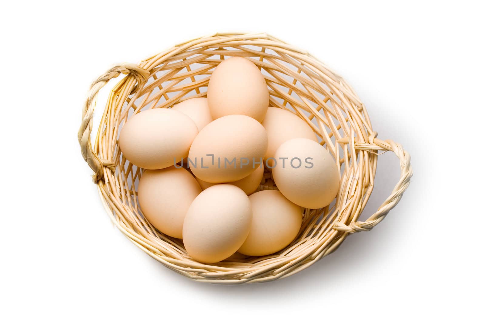 Brown eggs in the basket on white by Garsya