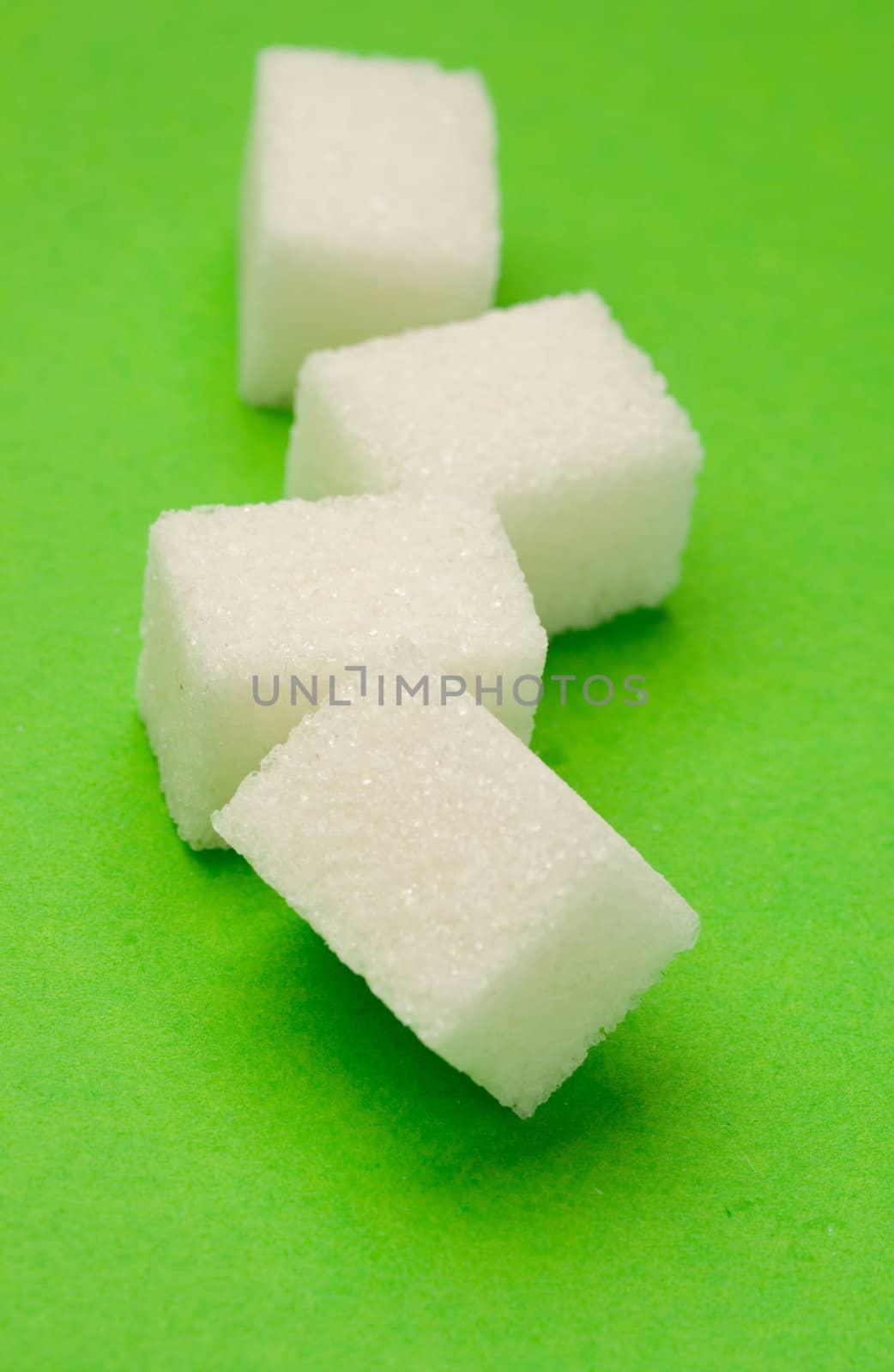 Sugar isolated on the green background
