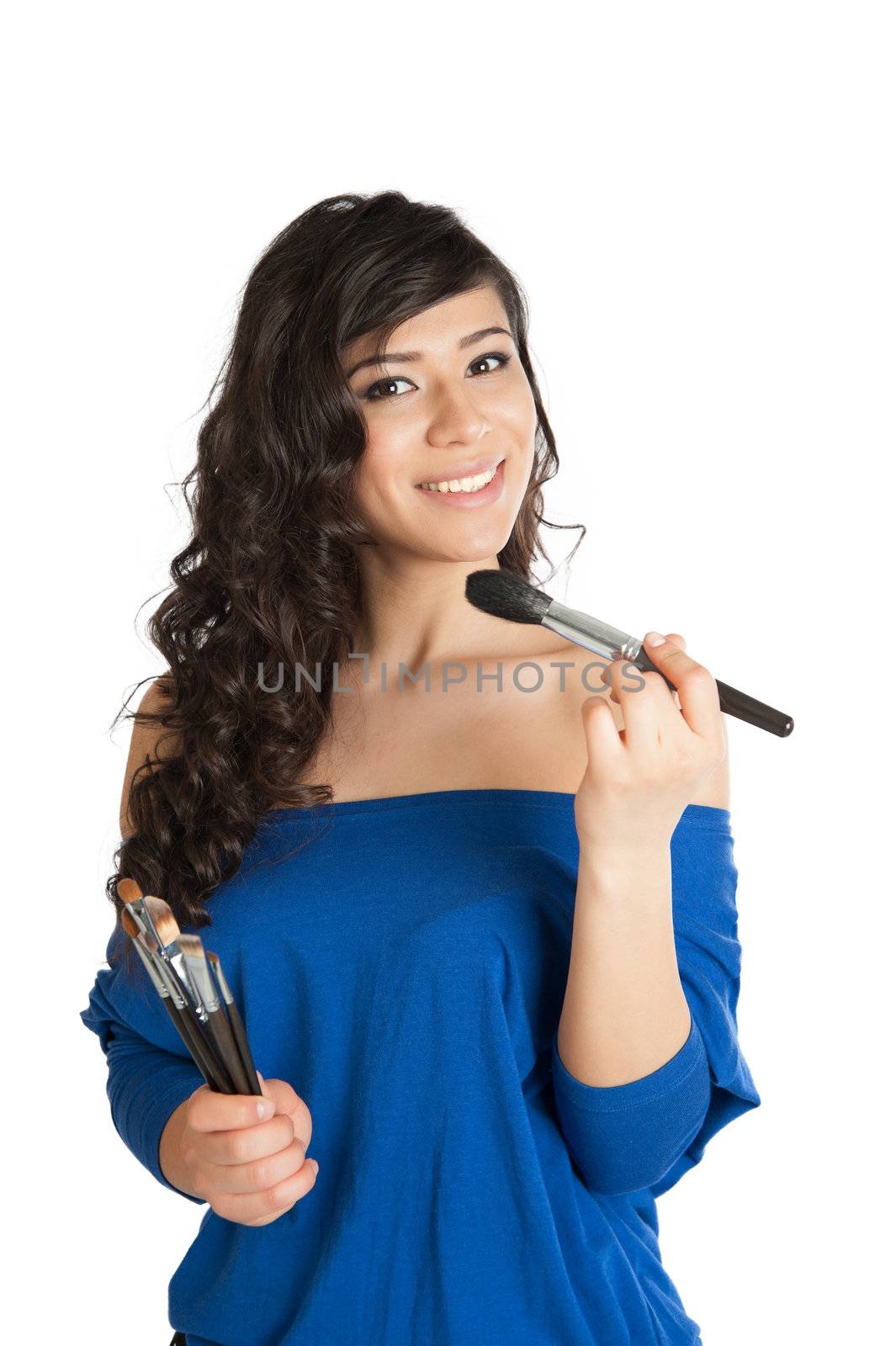 Beautiful woman with bare shoulders holding a paintbrush