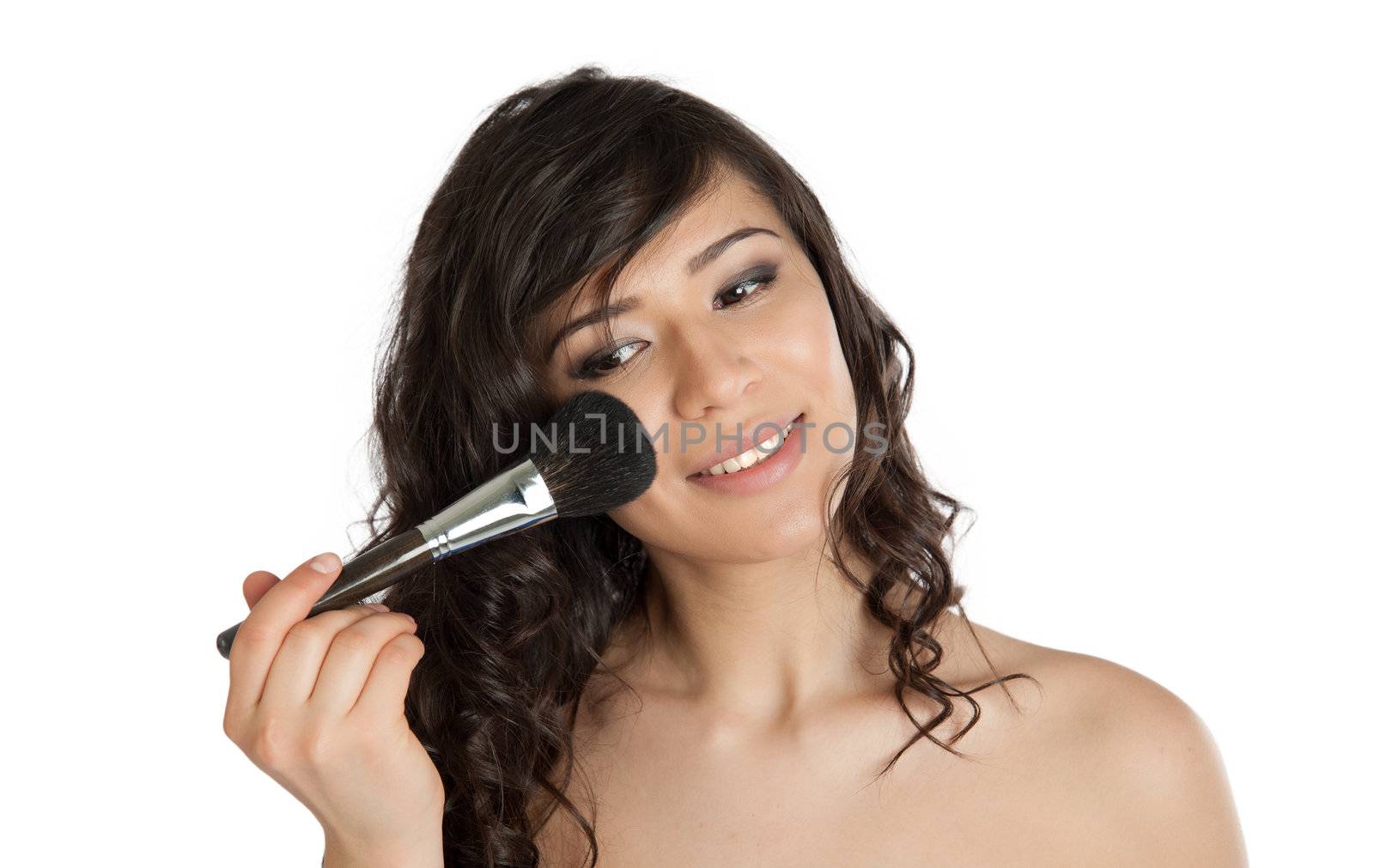 Woman apply makeup brush on the cheek.