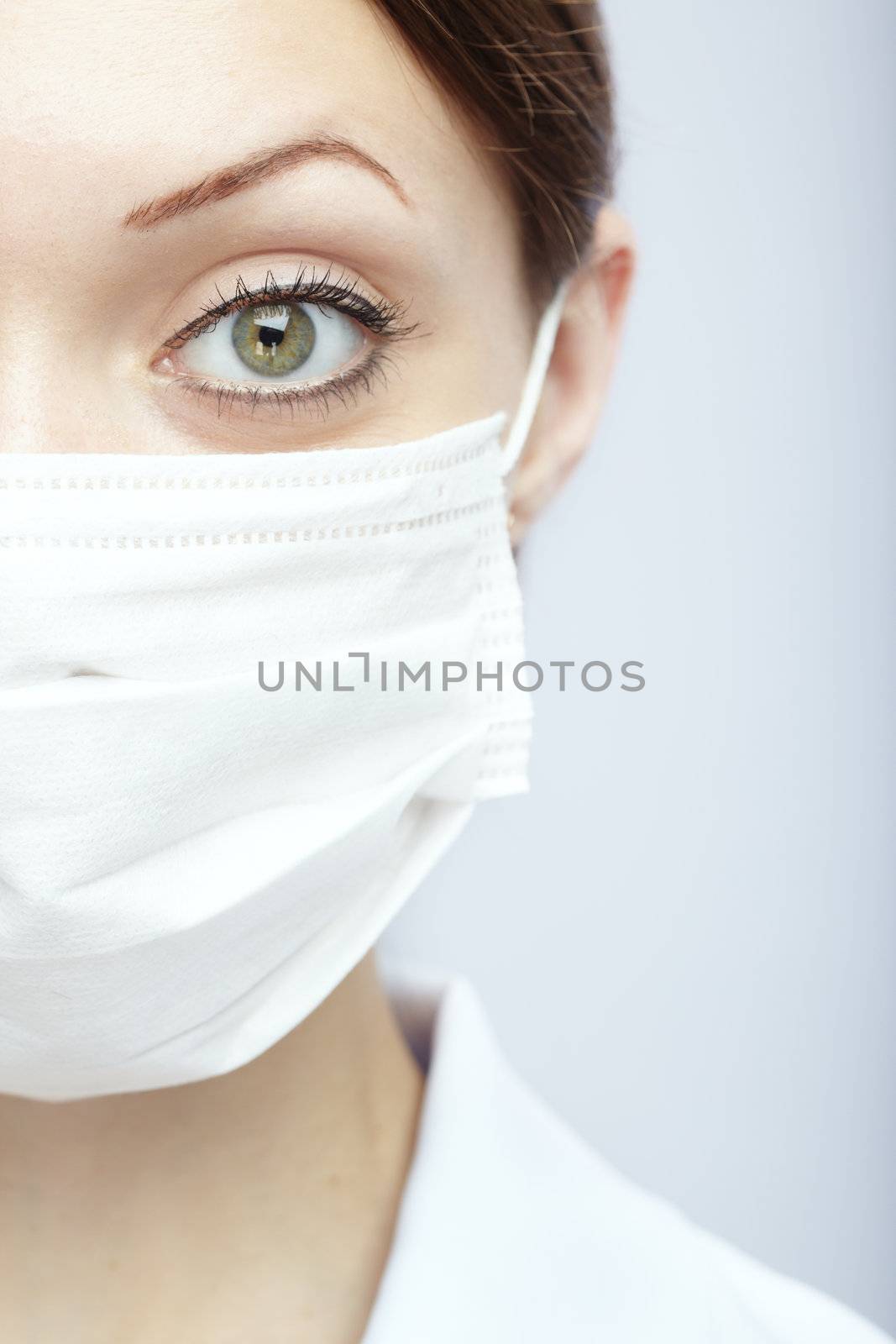 Female doctor in protective mask on a blue background