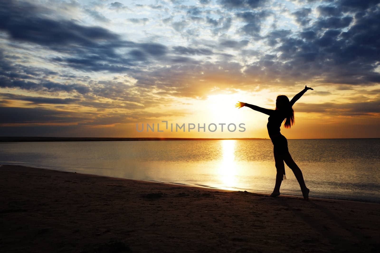 Beautiful sunset and elegant lady making exercise