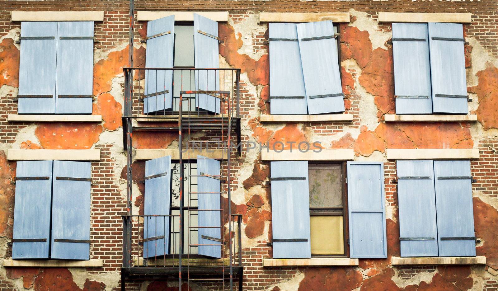 Shutters on the exterior wall of an old city building