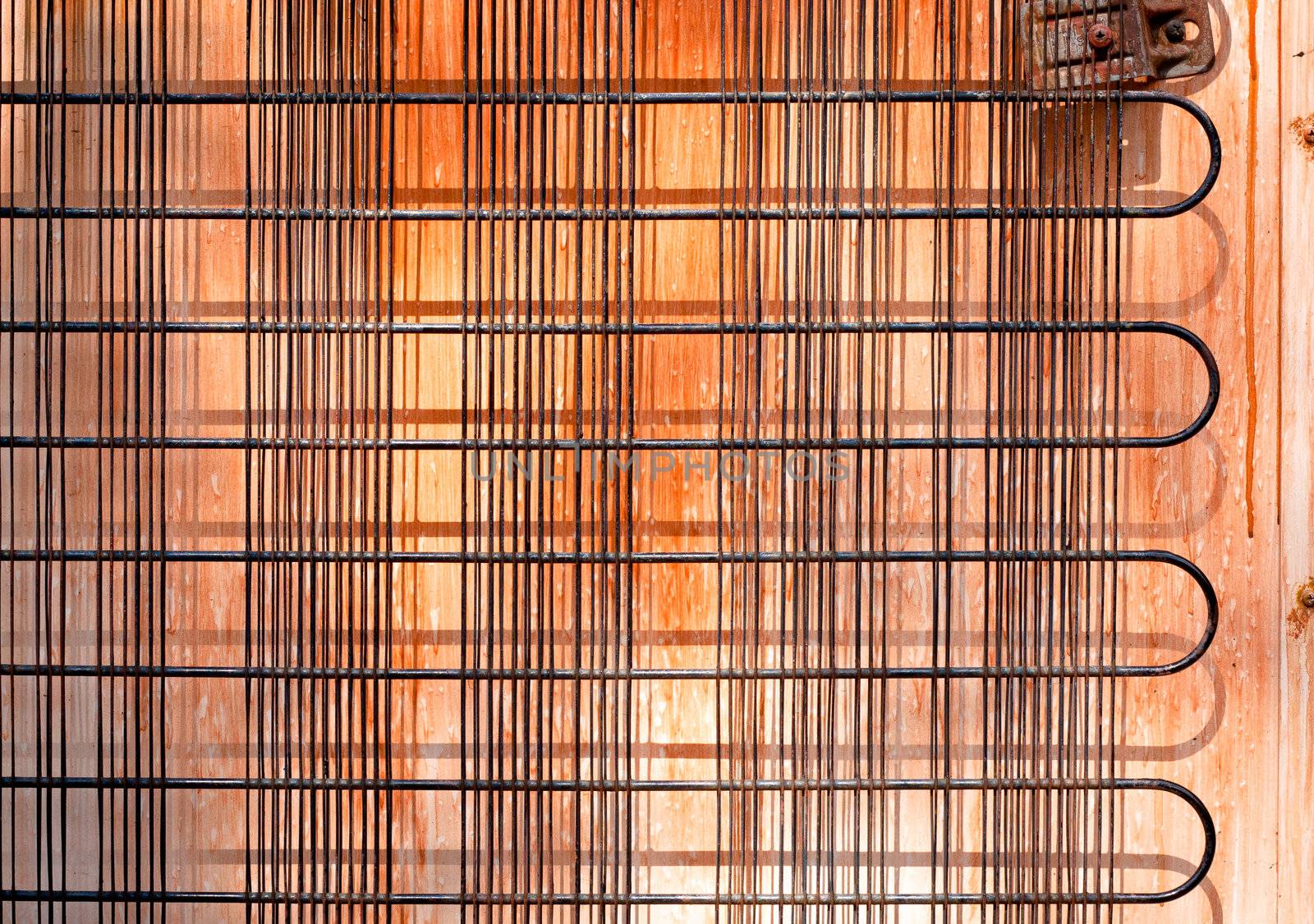 Rusty old cooling unit on the rear of a refridgerator