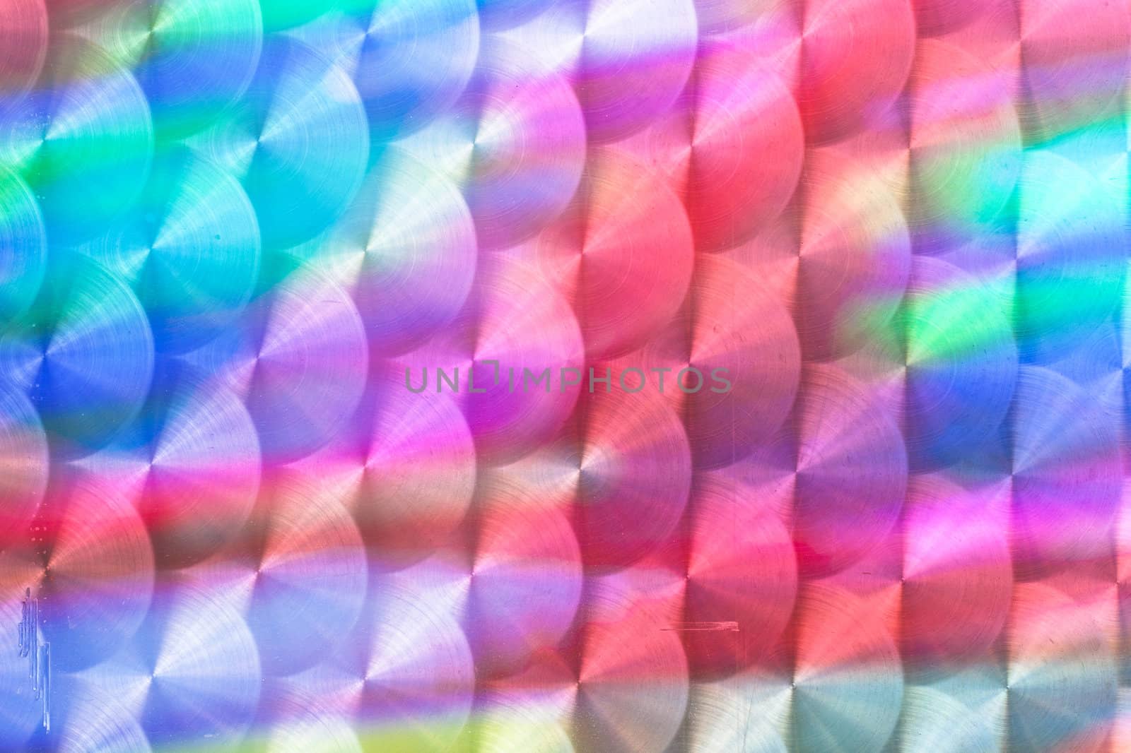 Colorful light reflected in a textured metal surface