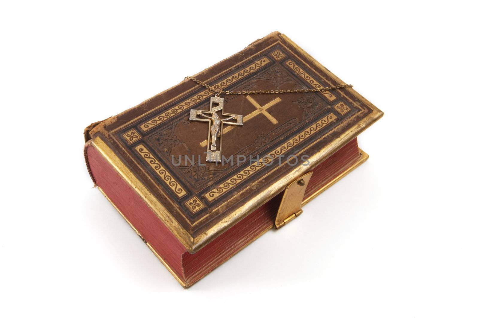 Cross on a religious book, isolated on a white background
