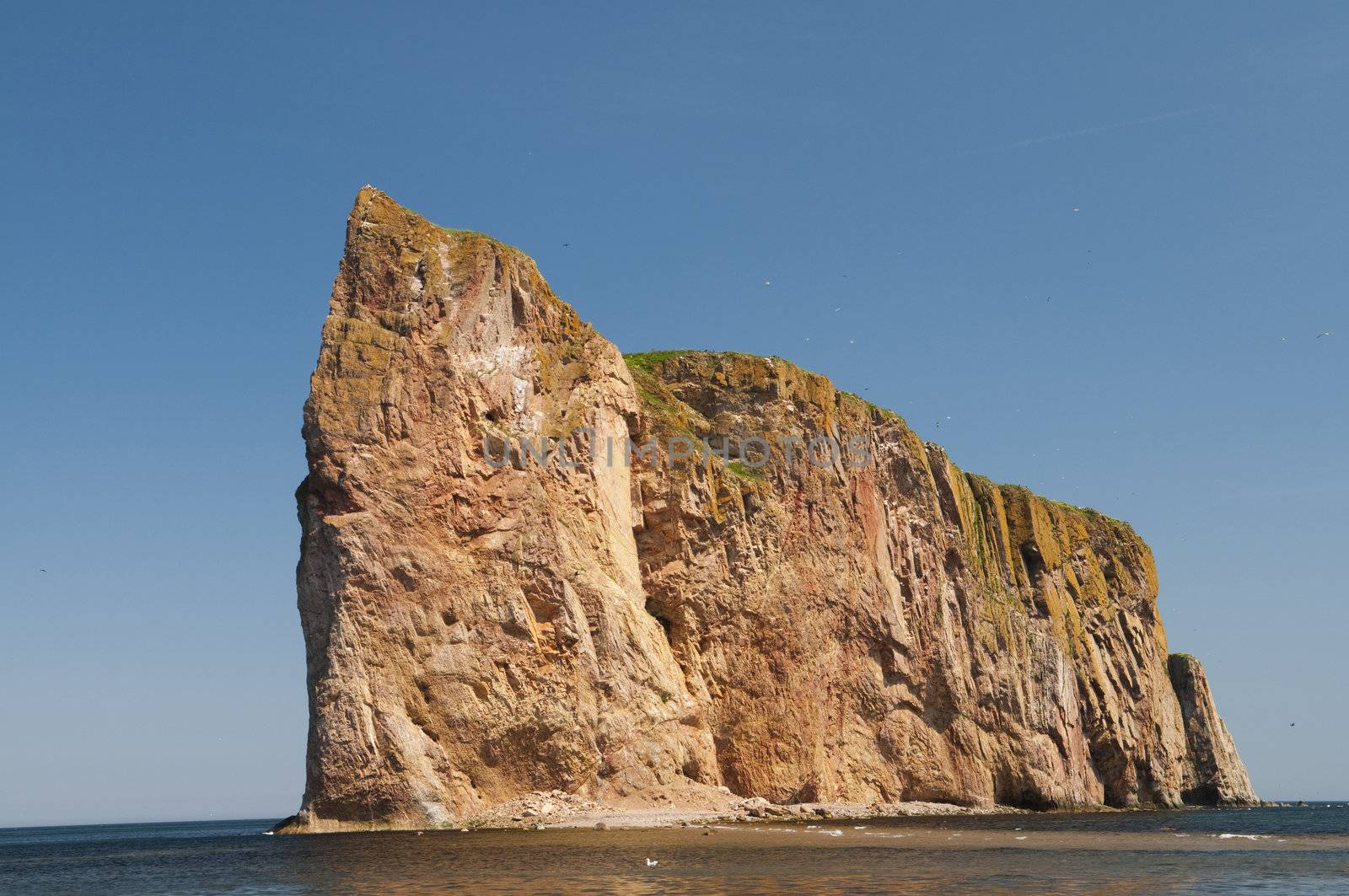 Looking up at the Perce Rock famous landmark located on the Gaspe Peninsula, Quebec, Canada