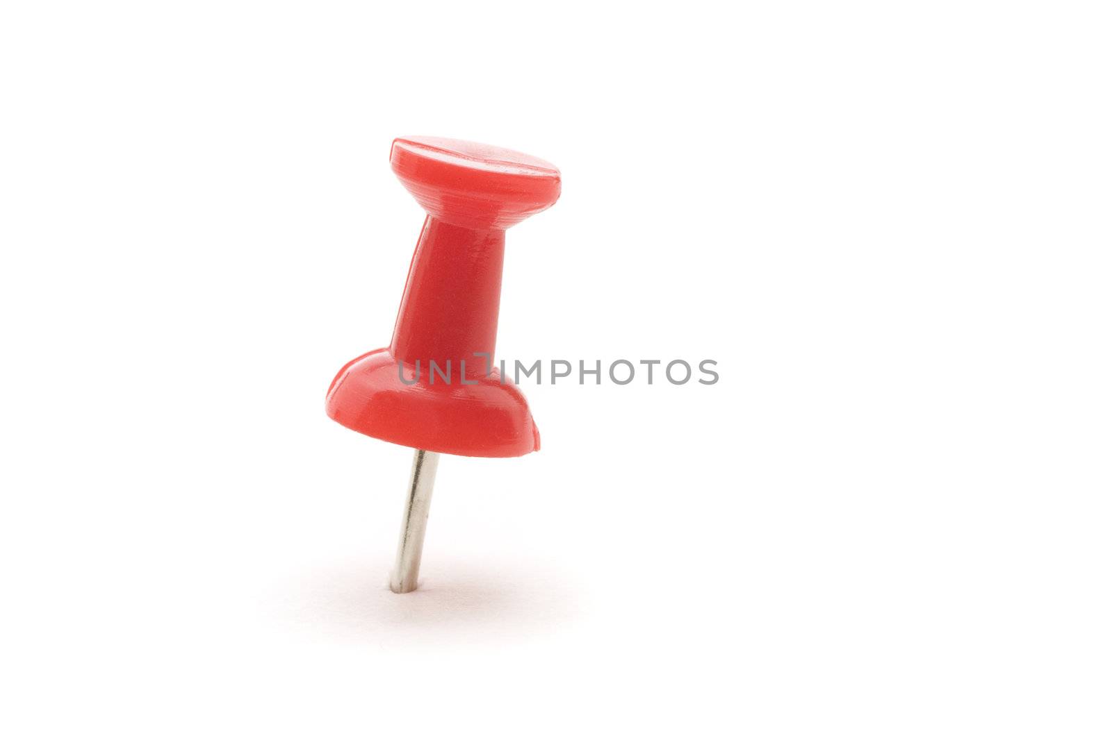 Macro of a single pushpin on white background