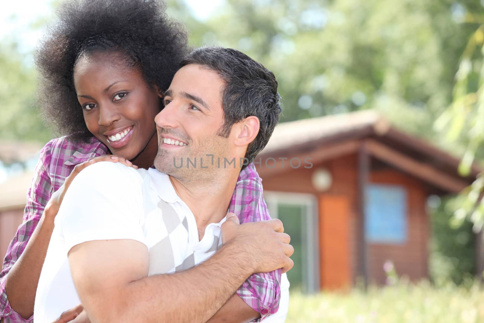 Couple in front of chalet by phovoir
