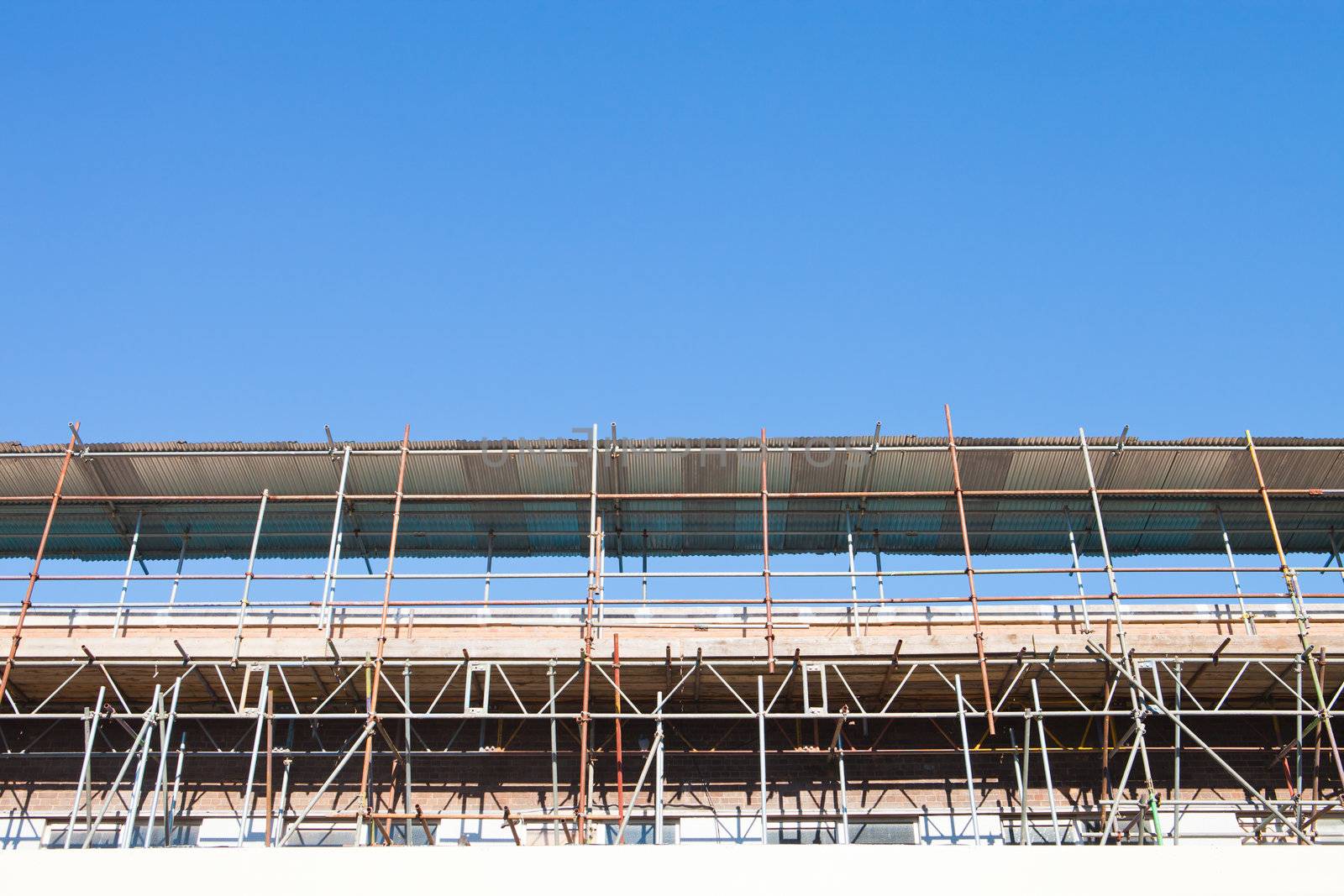 Scaffolding at a construction site in the UK on a sunny day