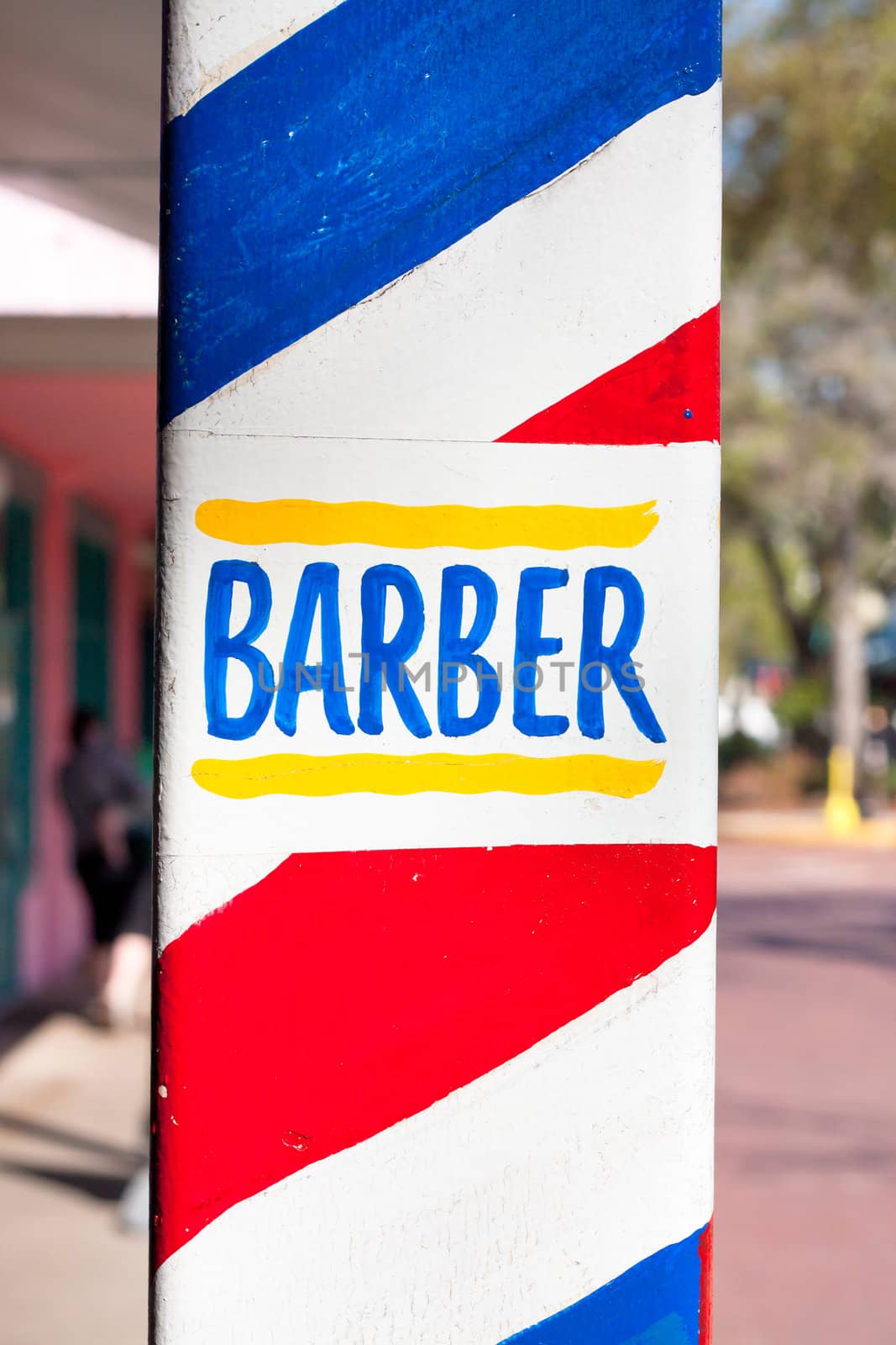 Close up of a colorful sign for a barber shop