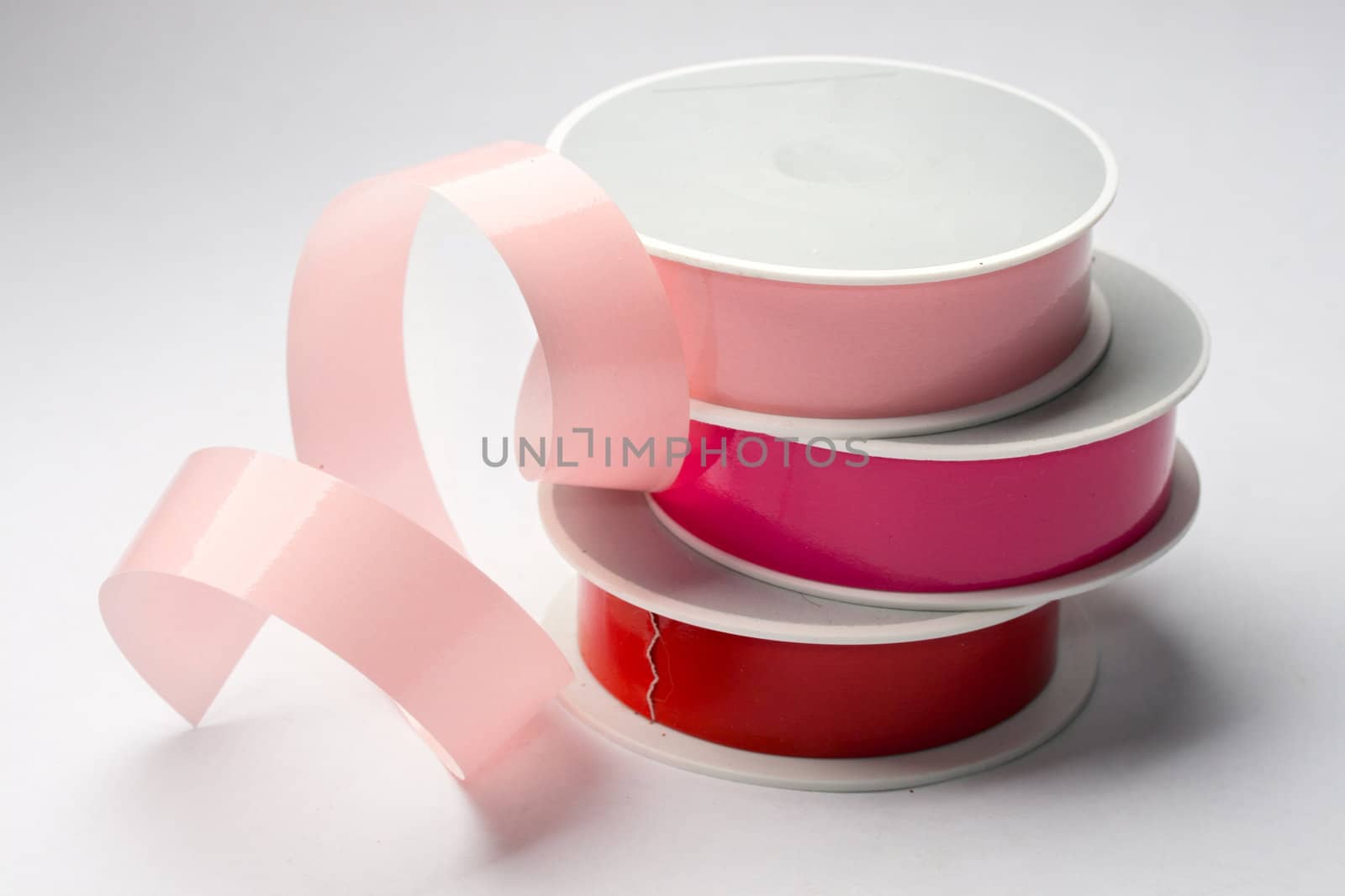 Reels of ribbon isolated on the grey background by Garsya