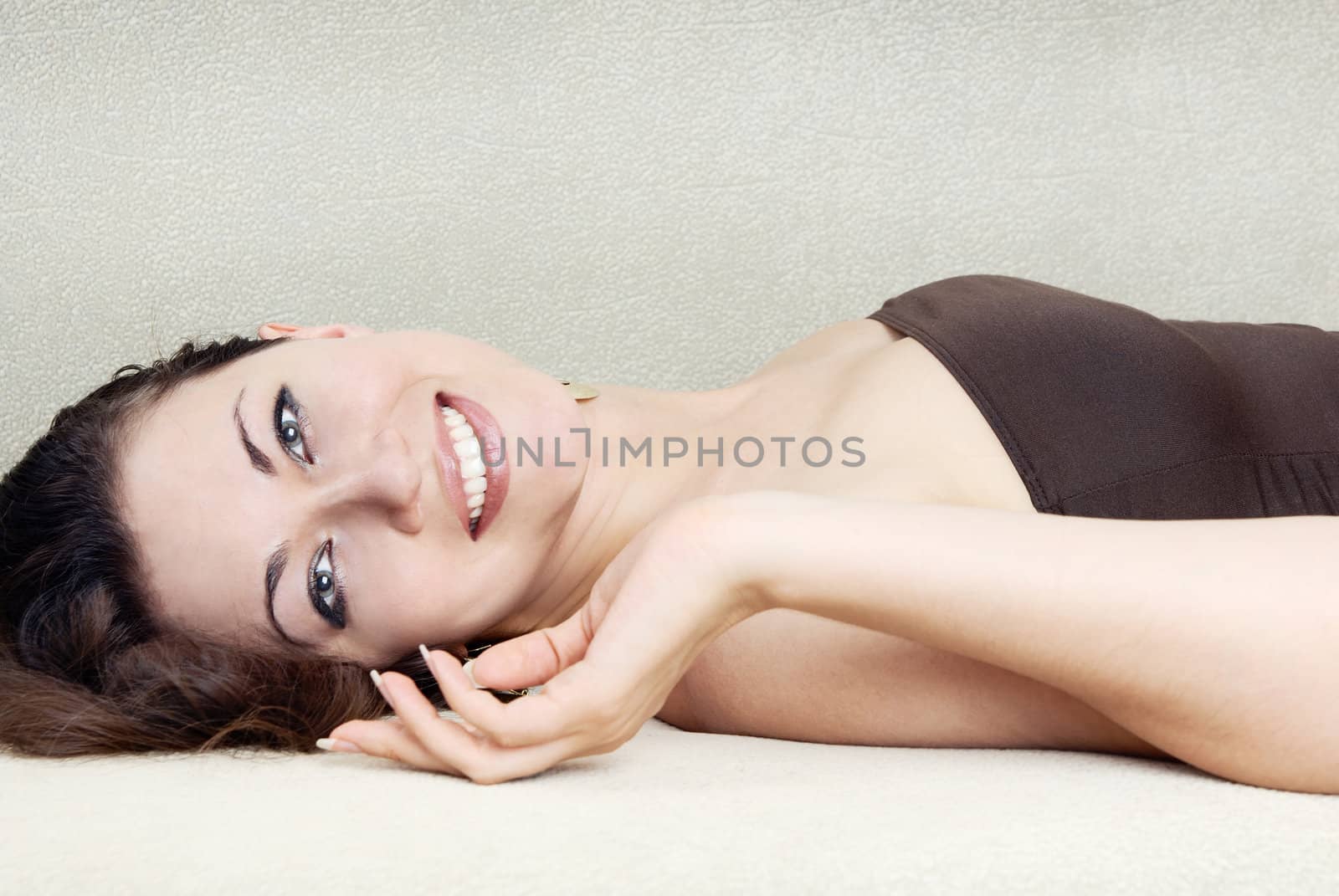 Photo of the smiling woman pampering on a sofa