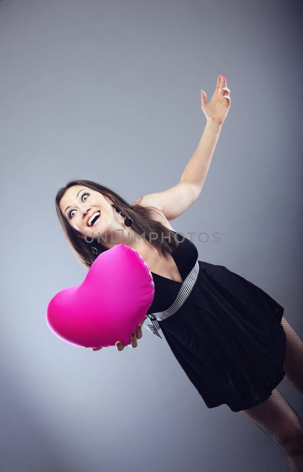Happy laughing lady giving the Valentine heart