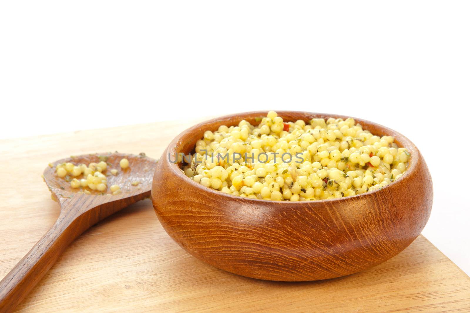 bowl of fresh cous cous salad on a white background