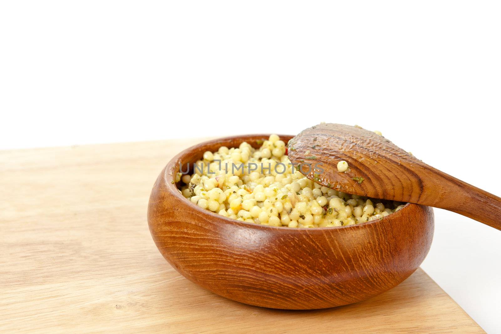 Bowl of fresh cous cous salad on a white background