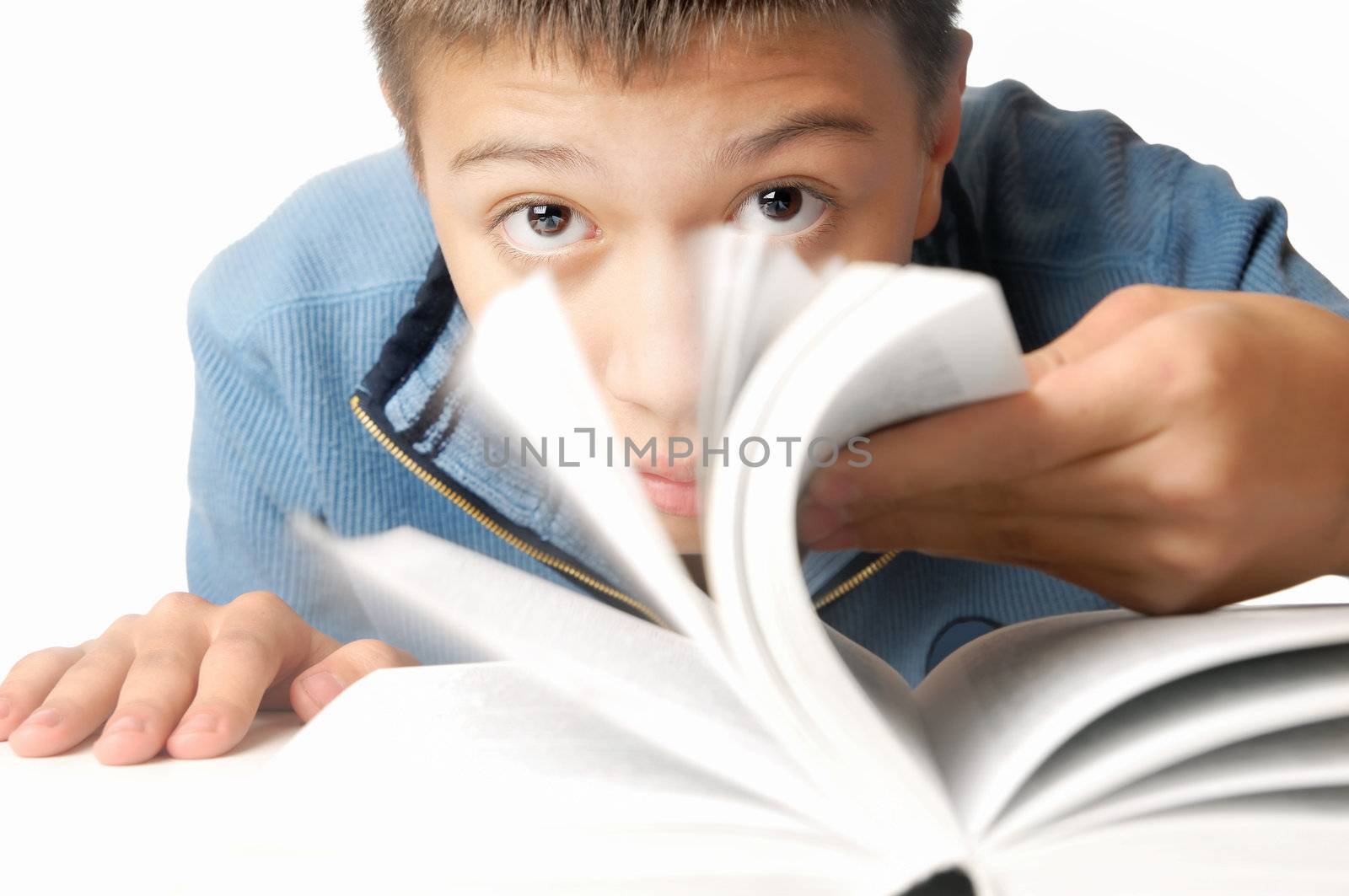 Young boy turning pages of the book