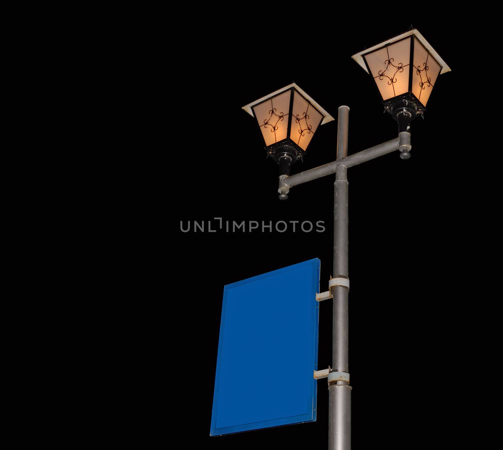 Street lantern with billboard isolated on black