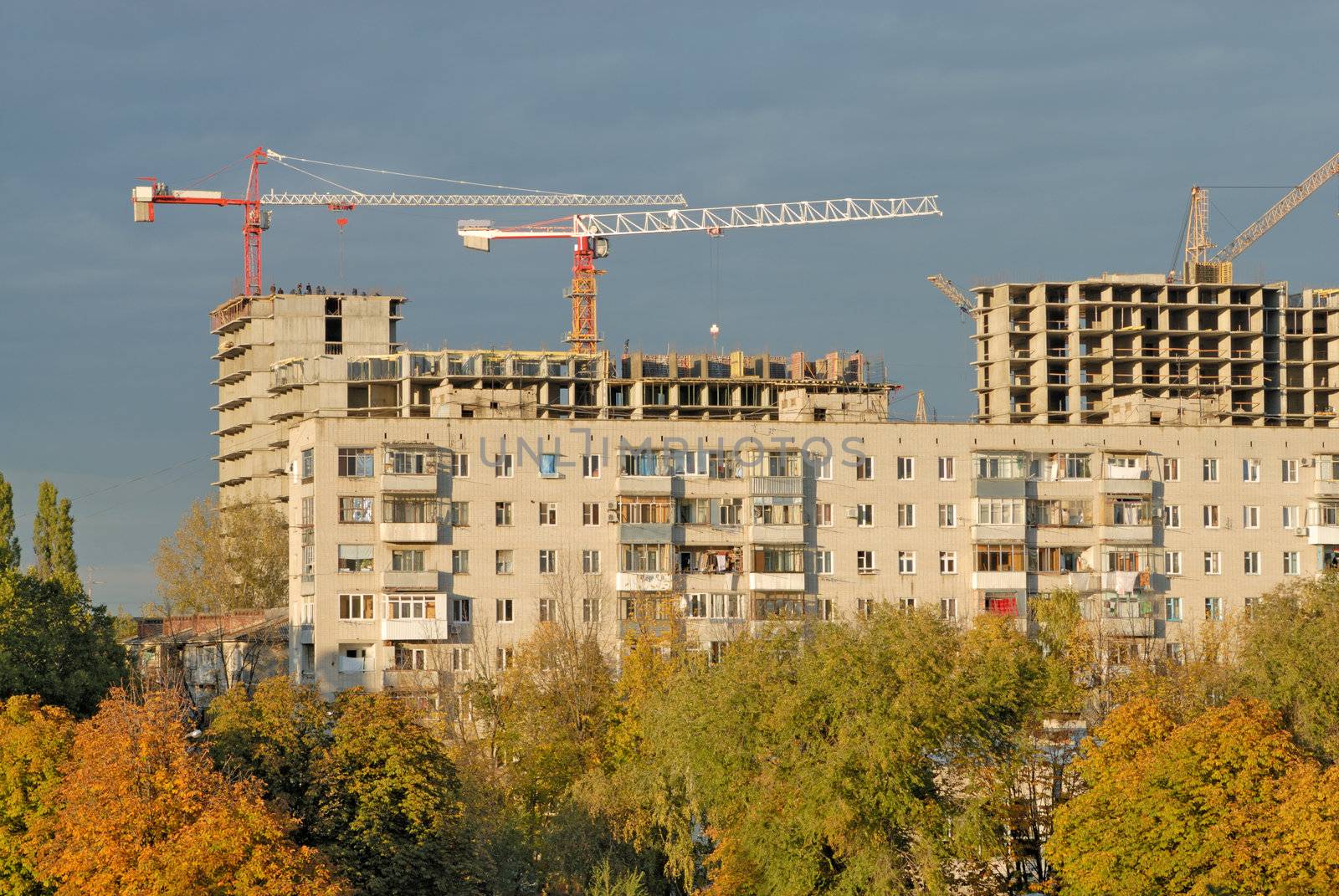 Old apartment house against construction crane by mahout