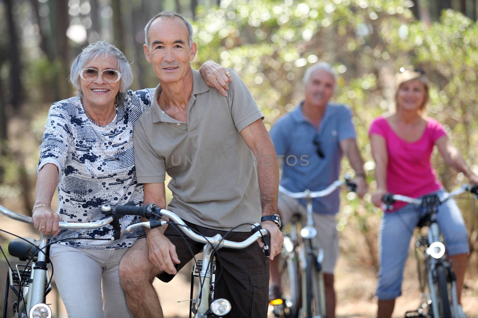 Elderly people riding their bikes by phovoir