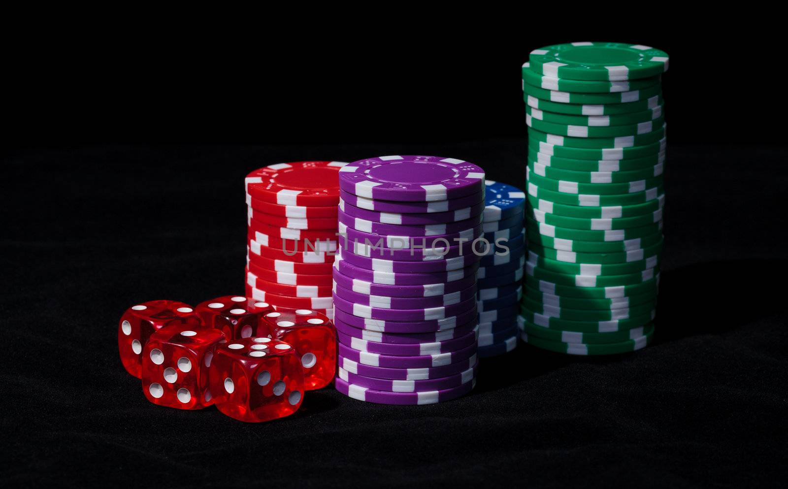 Stacks of Poker Chips with Playing Bones, closeup on black background