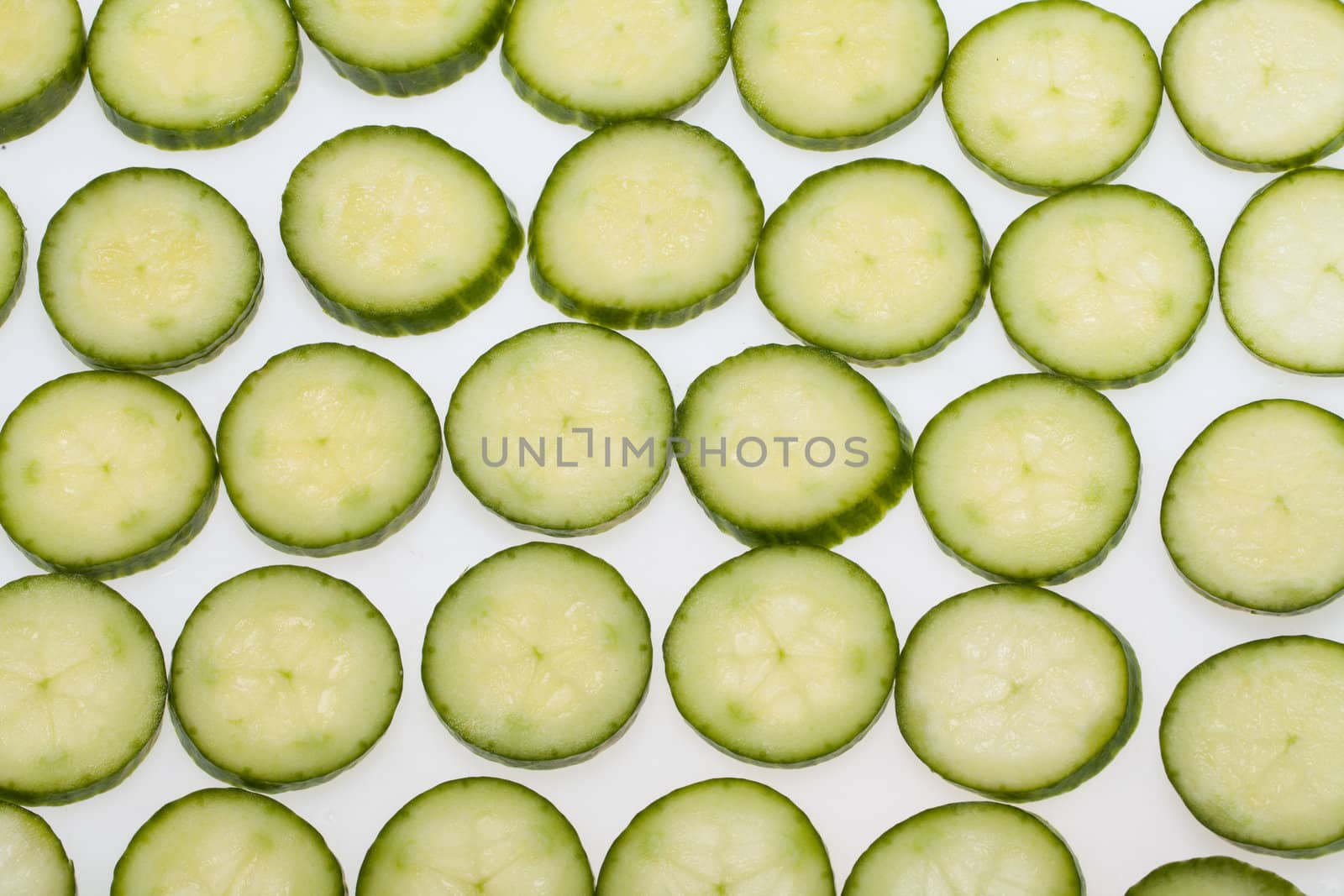 Freshly sliced cucumber  isolated on white background 