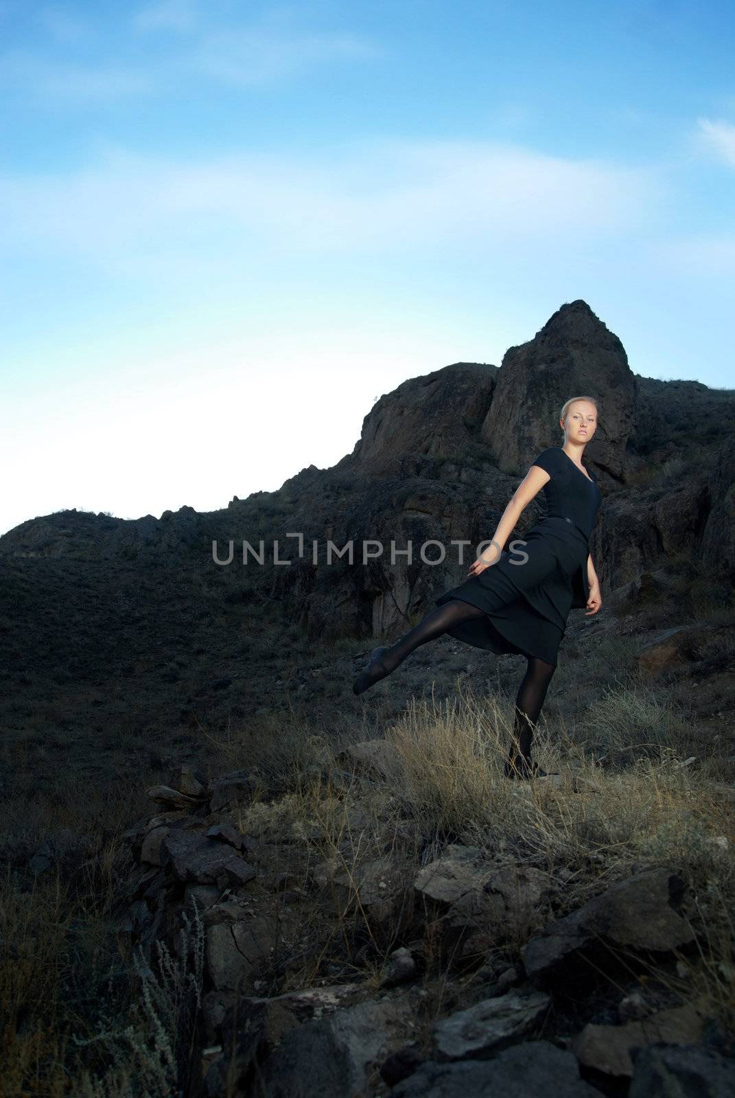 Photo of the ballet dancer and sunset at the background