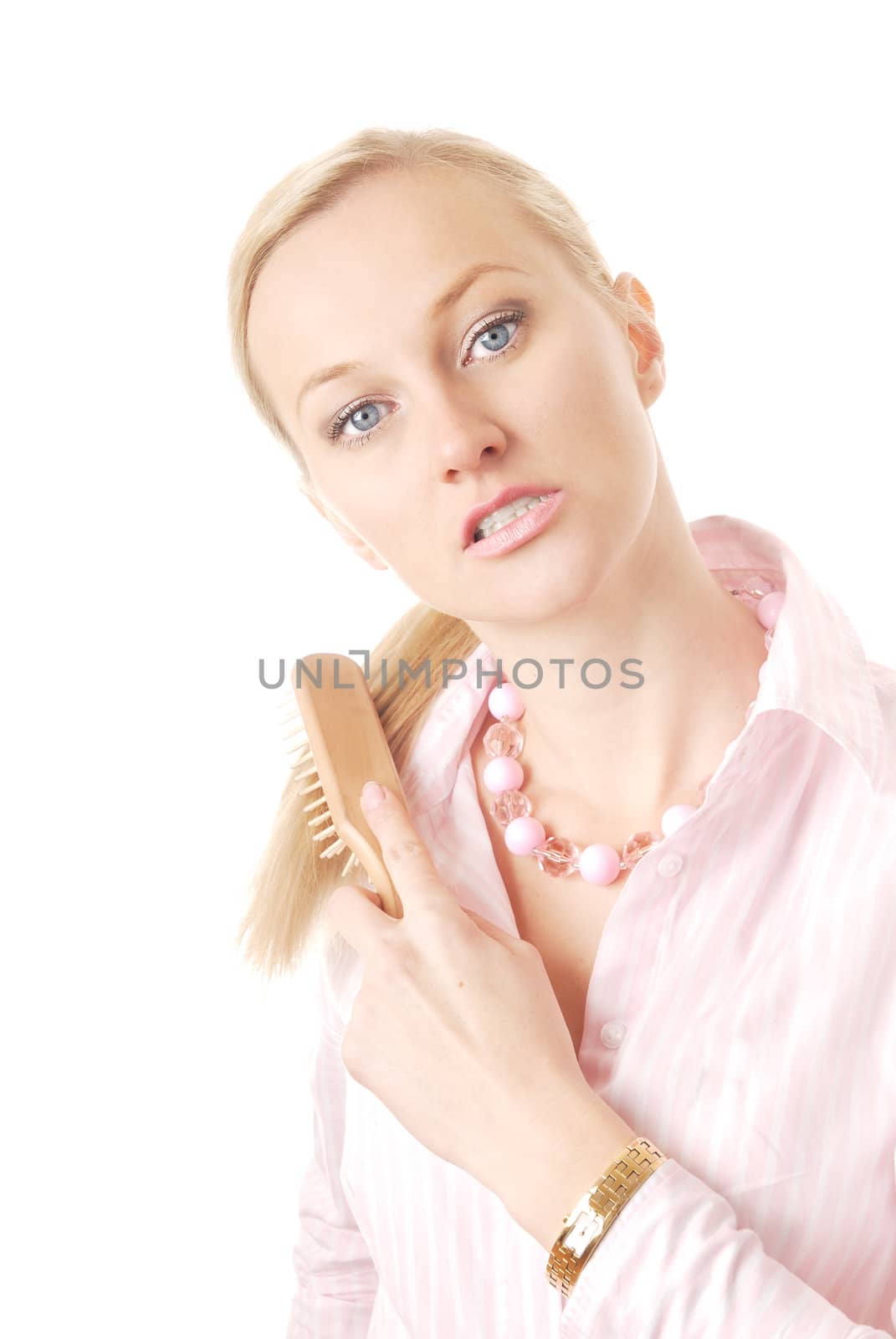 Sensual photo of the blond with rake-comb on a white background