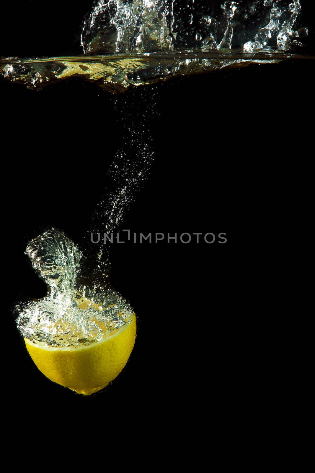 fresh lemon under water by sergey_nivens