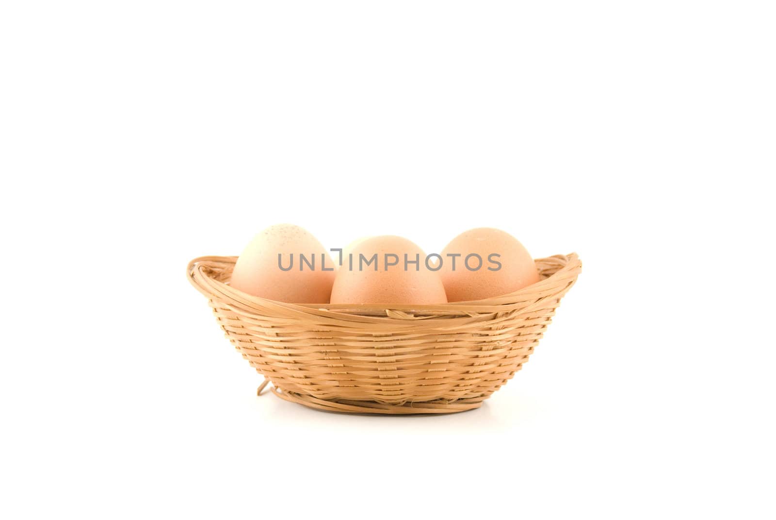 eggs in a wicker basket on white background