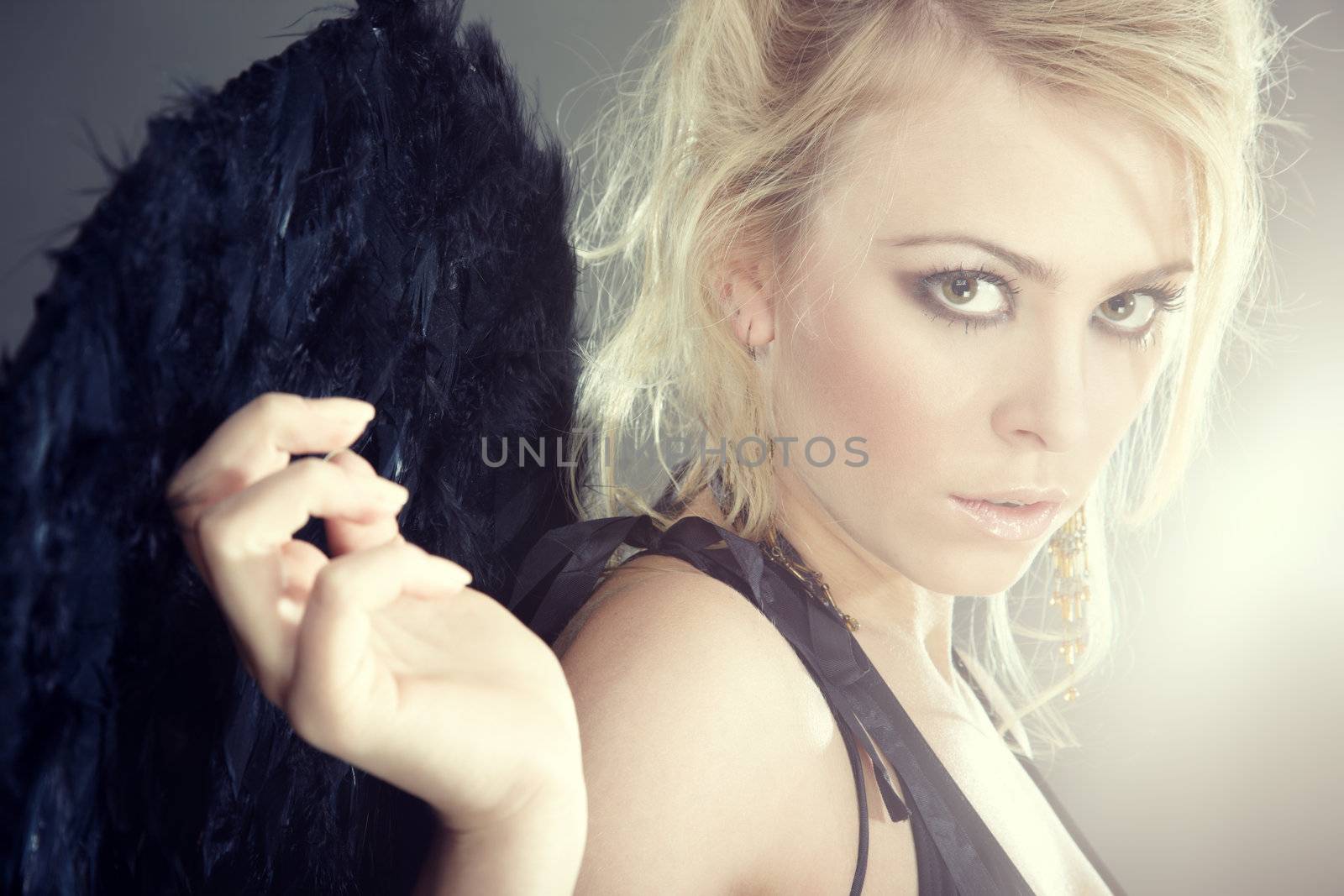 Portrait of the blond female angel with artificial wings