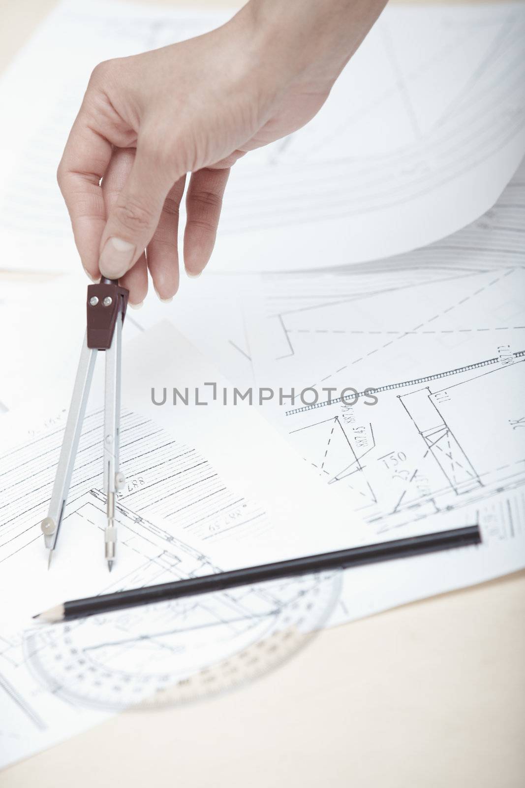 Hands of engineer working on a construction plan