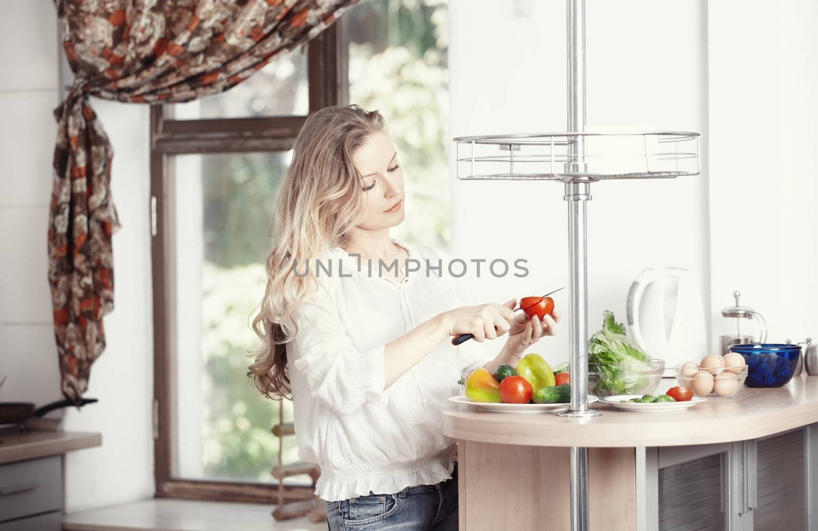 Blond lady at kitchen preparing vegetable for breakfast