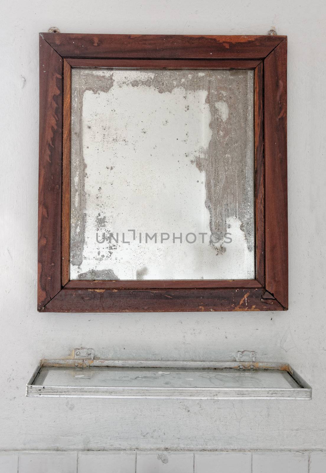 Mirror in a dilapidated bathroom by dutourdumonde