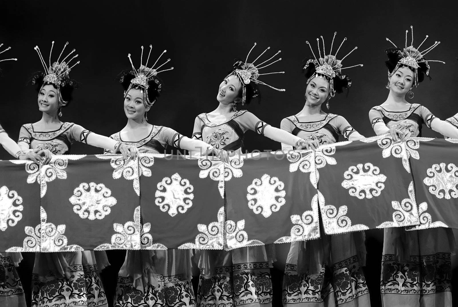 CHENGDU - DEC 13: chinese Yi ethnic dancers perform folk group dance on stage at JINCHENG theater in the 7th national dance competition of china on Dec 13,2007 in Chengdu, China.