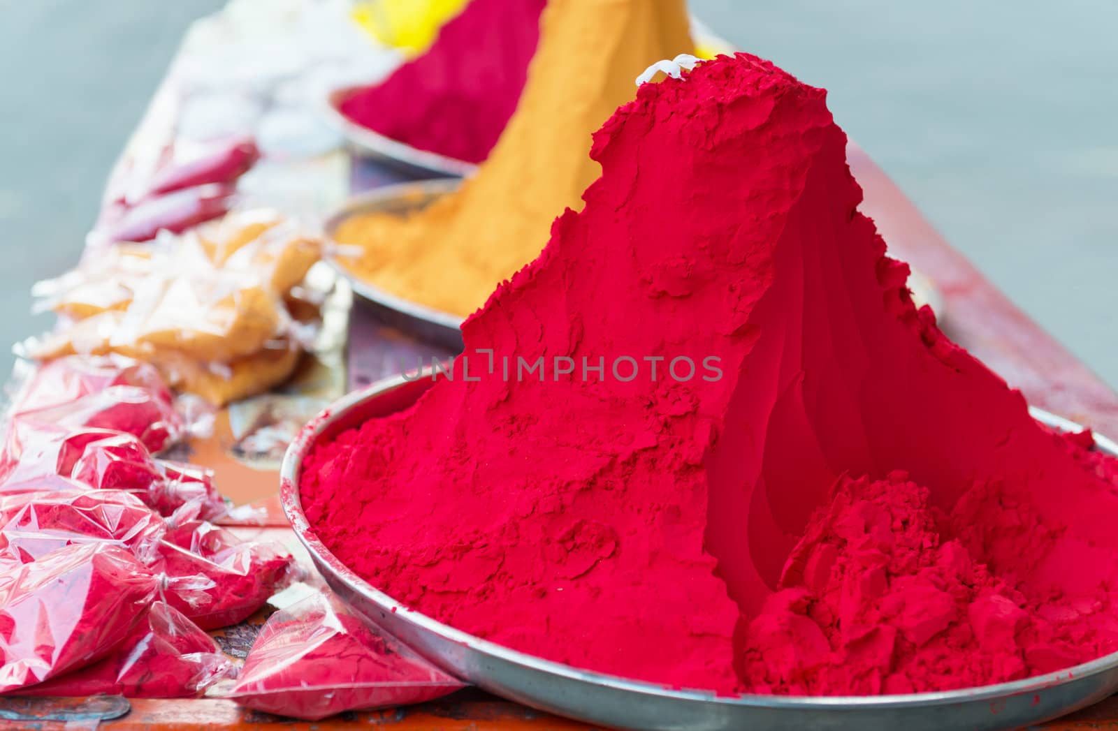 Piles and mounds of Indian colorful dye powders for holy festival and religious purposes at open market. 