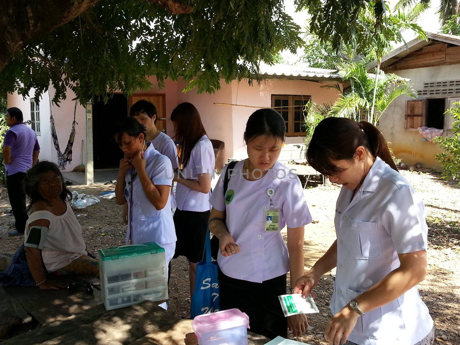 KANCHANABURI, THAILAND - JULY 30: A group of medical students do physical examinations and give knowledge to old people for primary prevention of disease on July 30, 2012 in Kanchanaburi, Thailand