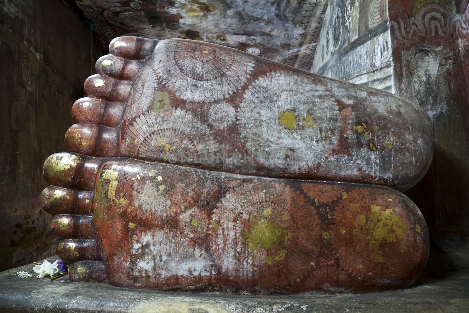 closeup feet of reclining buddha in dambulla cave, srilanka